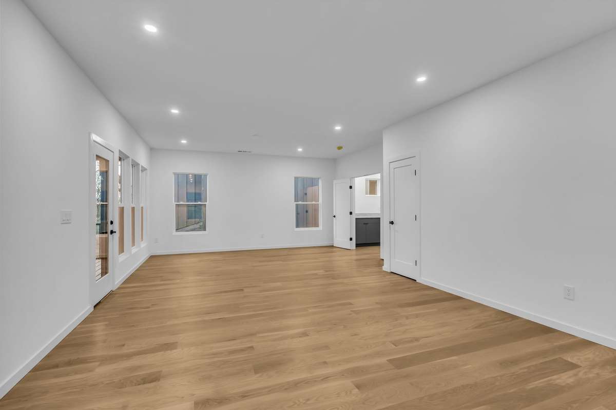 The rec room features more than enough space for a massive TV viewing setup and separate conversation or game table area with hillside views.