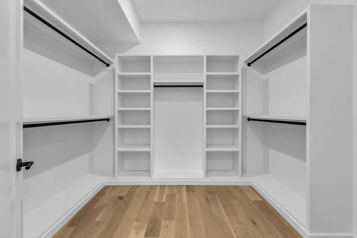 Large walk-in closet for the primary bedroom which includes stacked washer and dryer hookups