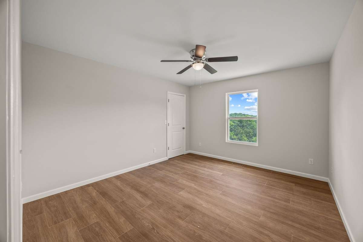 Bedroom #2 is large with a front yard/front ridge view, ceiling fan, and oversized closet!