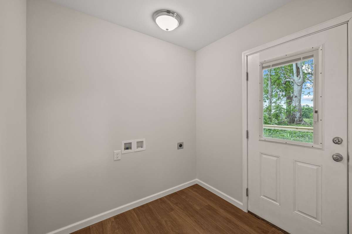 The laundry/mud room area has an entrance off the back deck and connects to a large storage closet/pantry area.