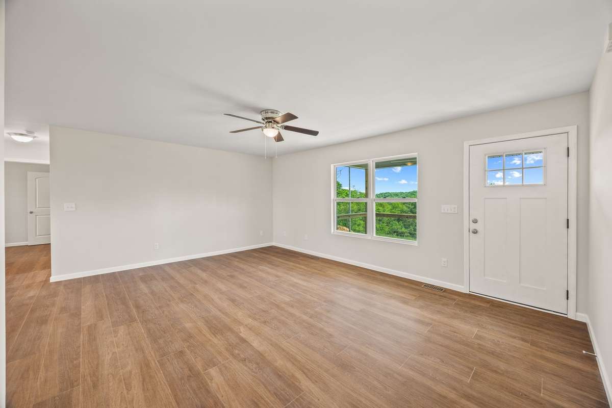 Entering your new home from the front deck, you will walk into the large living room with ceiling fan and fantastic window view of the front yard!