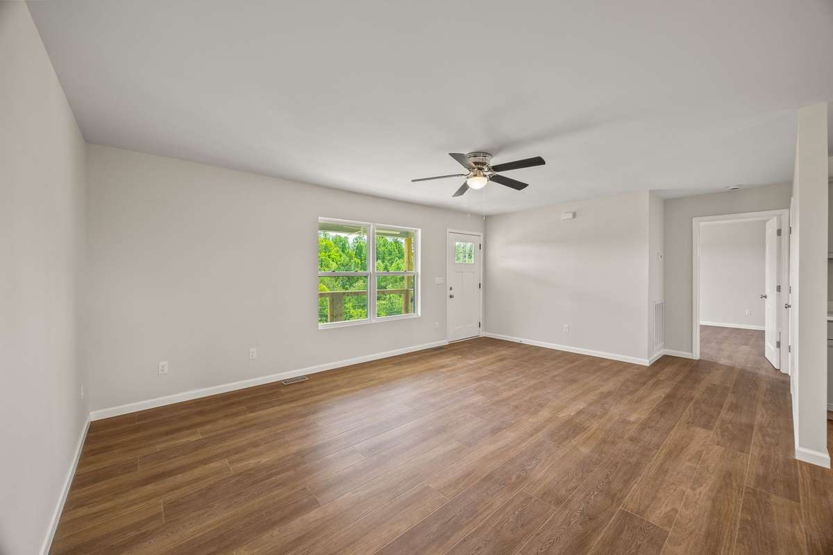 Off the living room is the primary bedroom (to the left) and the dining/kitchen combo straight ahead!