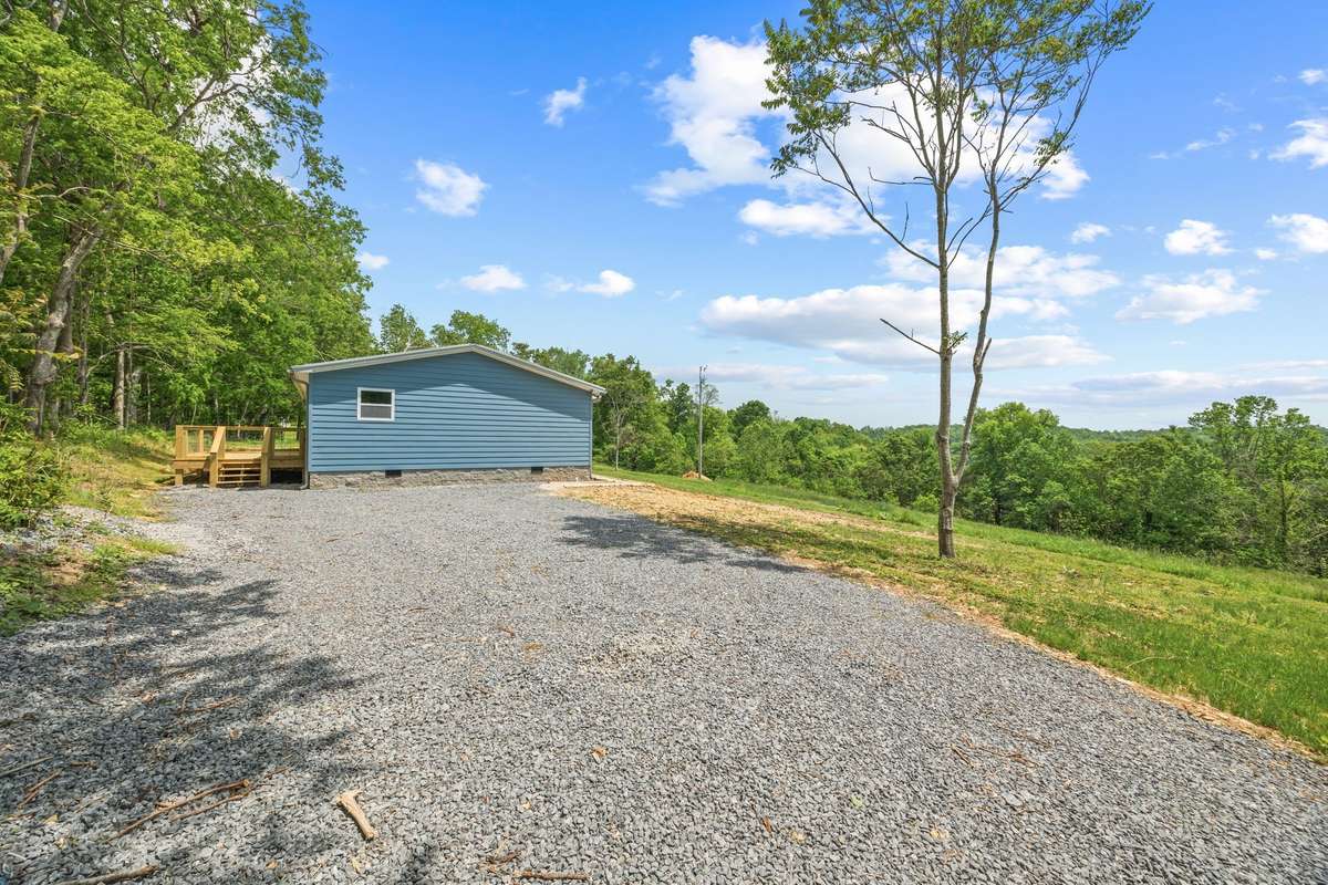 Wide driveway and plenty of space to add barns, sheds, or storage buildings to your property!