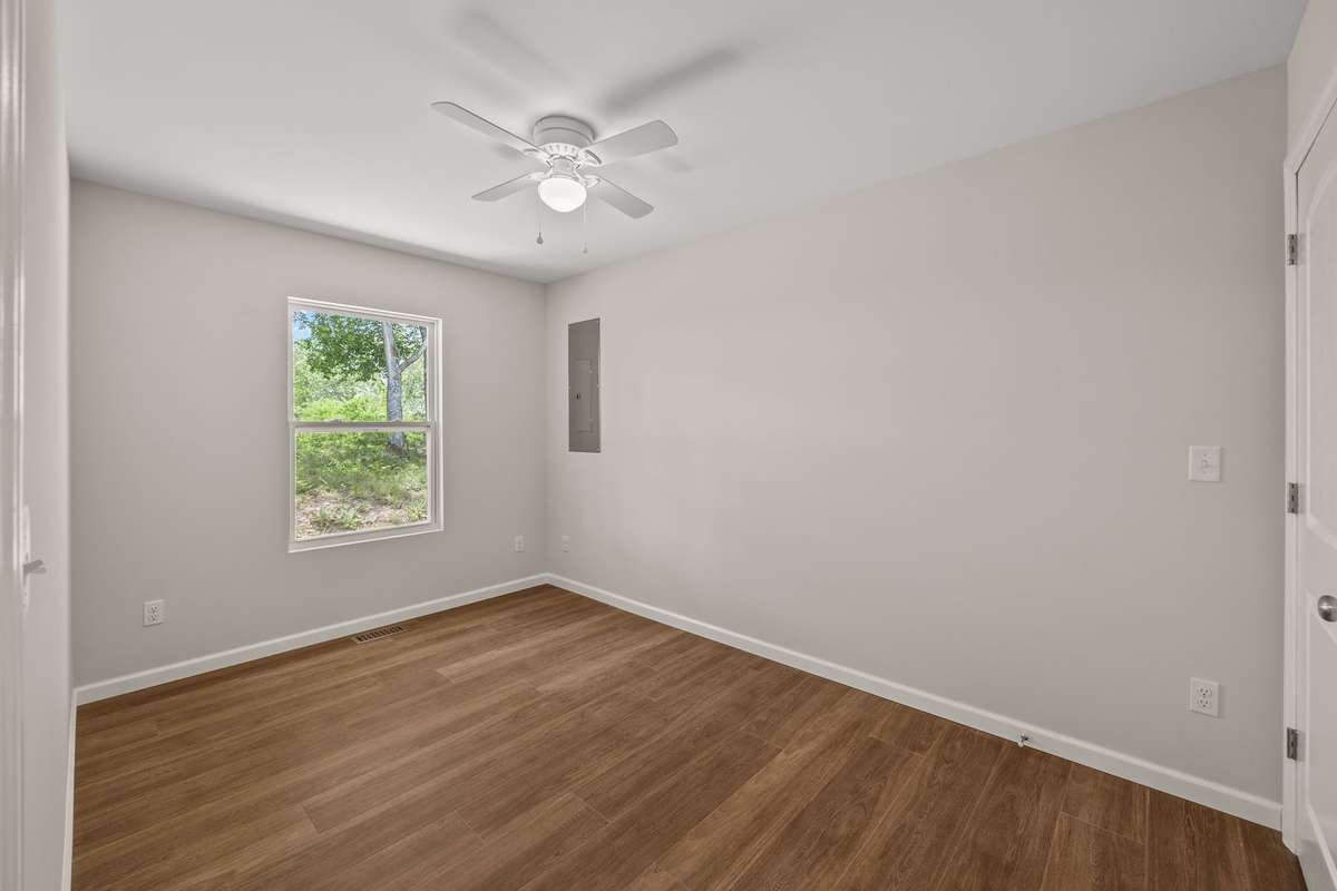 The office/bonus room has a ceiling fan and oversized closet with a view of the back ridge. There are lots of options for what you can do with this space!