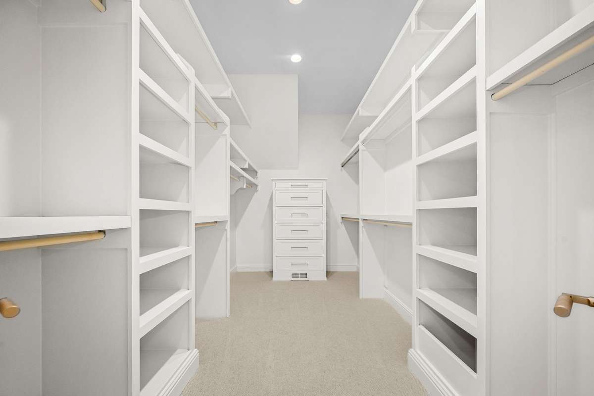 Custom Owner's Closet with built-in stacked ,soft closing drawers.