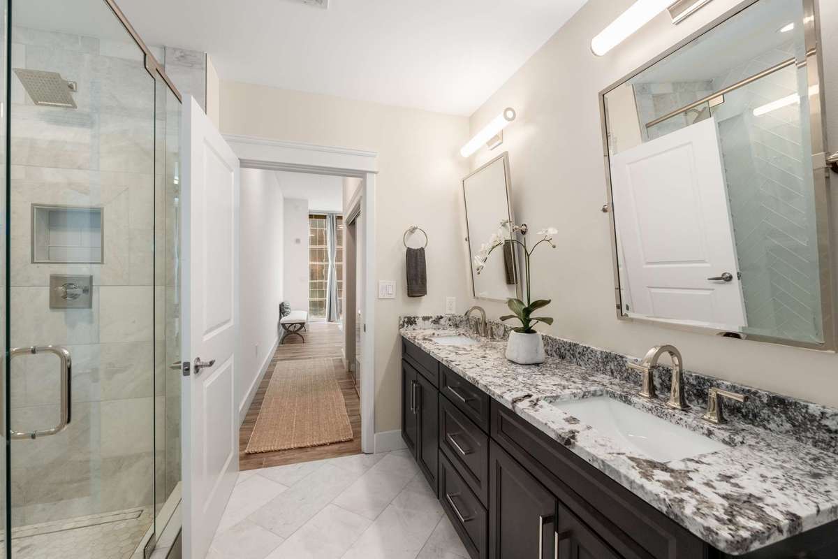 The primary bath has been fully renovated with heated tile floors, new vanity, countertops, plumbing, mirrors, lighting and stunning shower.