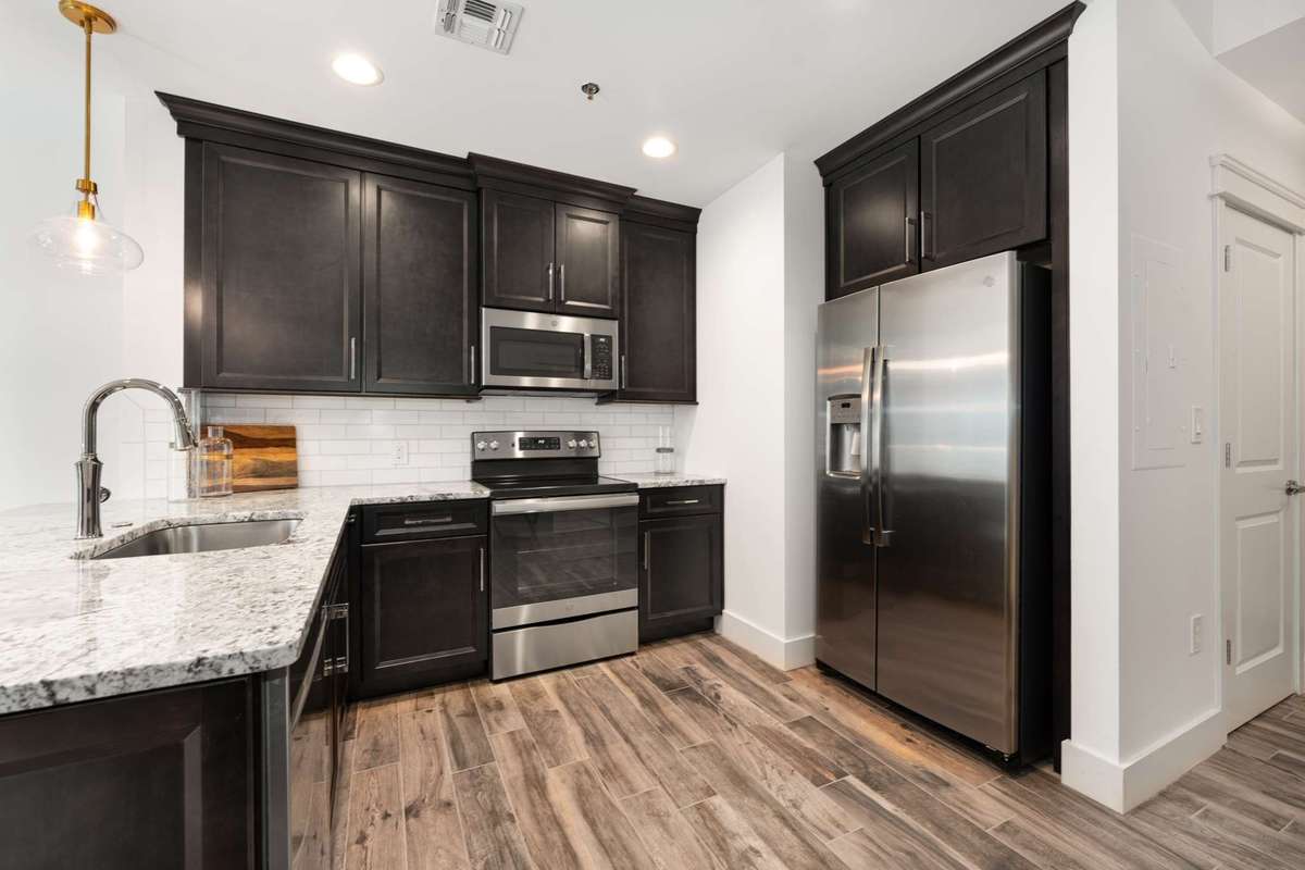 New countertops and tile backsplash contrast beautifully with the new custom cabinetry.