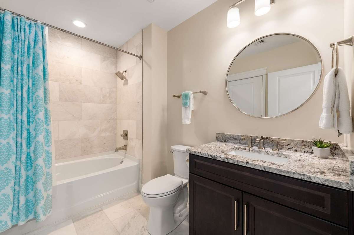 Treat your guests to heated tile floors, a soaking tub, and fresh tile that rises to the ceiling.