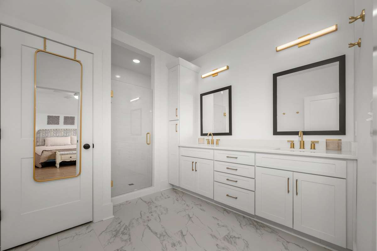 Spa-like bathroom with dual sink vanity, private water closet, and tiled shower with bench seating!