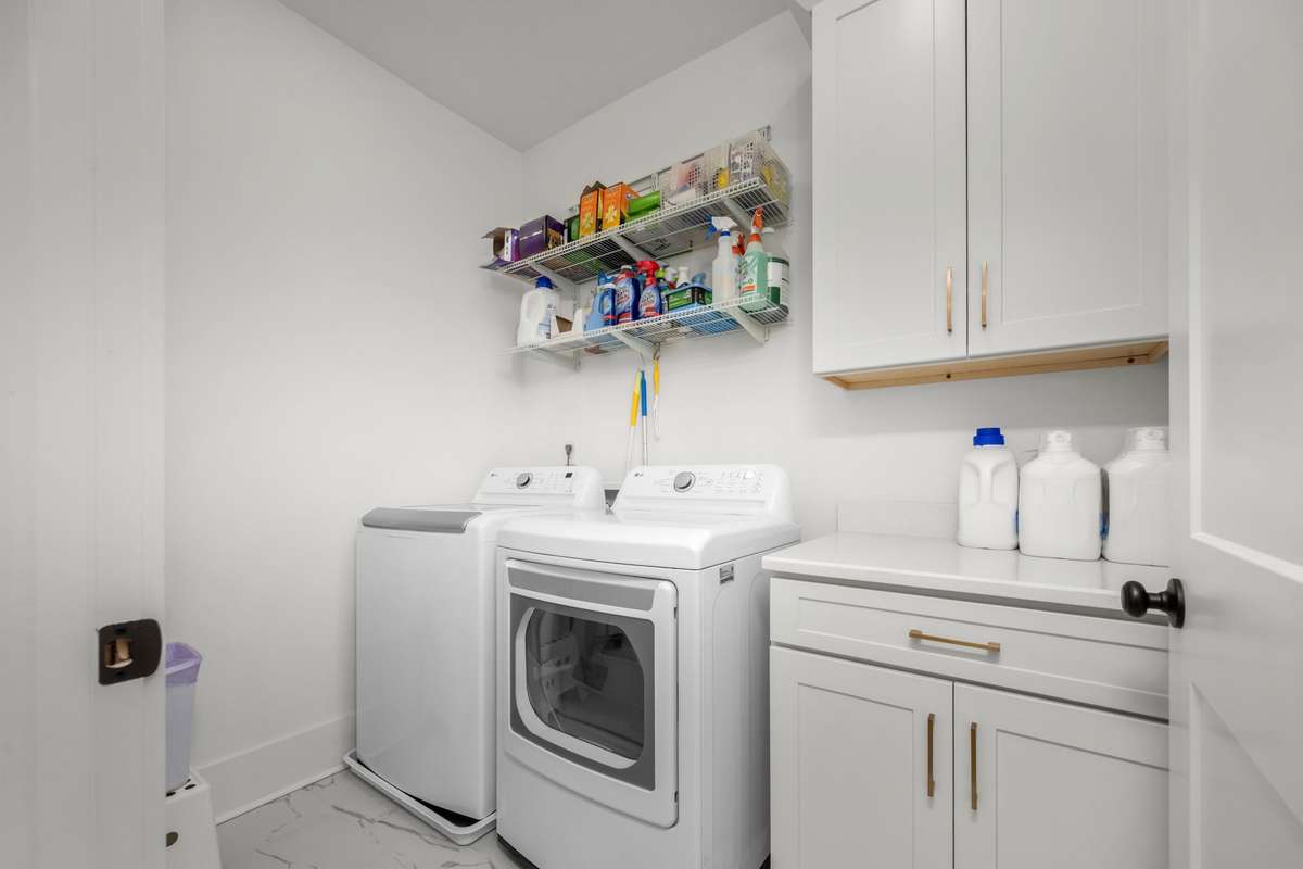 Dedicated laundry room with storage cabinets!