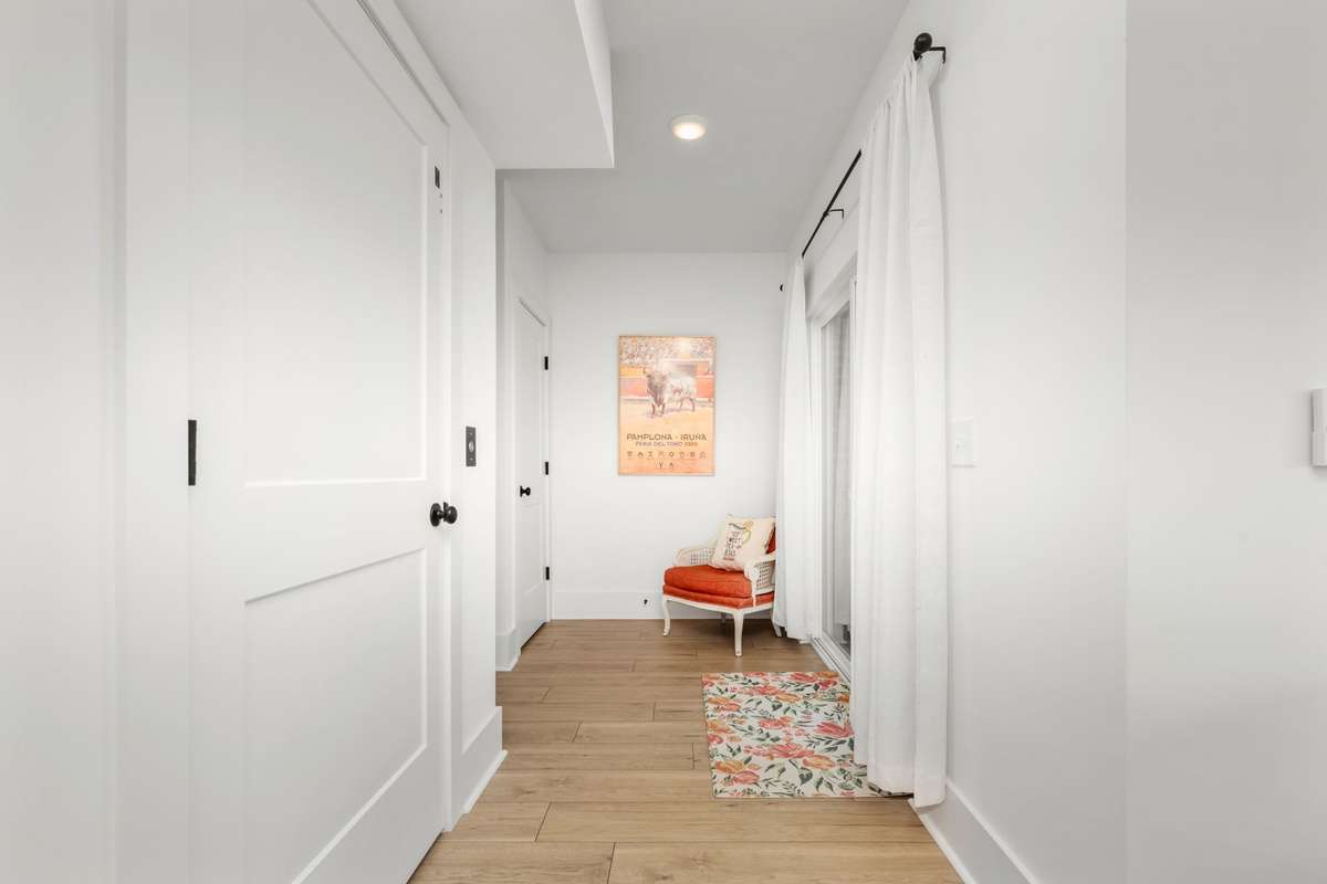 Hallway in the basement featuring access to the elevator, huge storage closet, and patio access