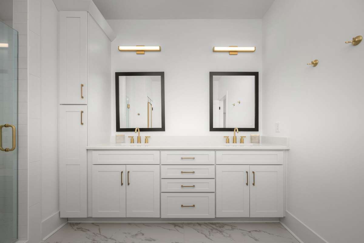 Spa-like bathroom with dual sink vanity, private water closet, and tiled shower with bench seating!