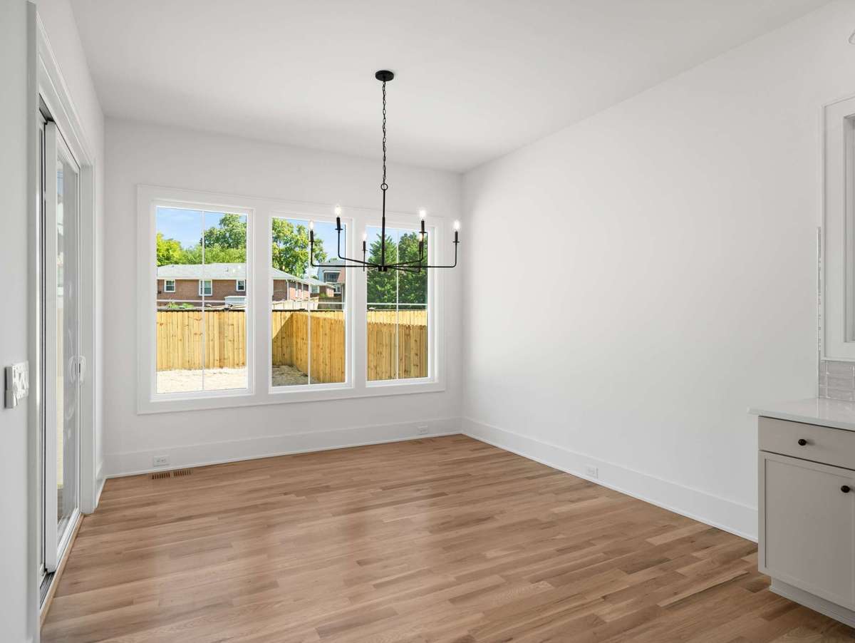 Dining space overlooking fenced in backyard