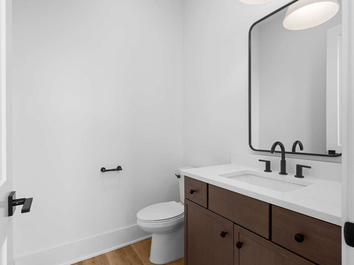 The main floor powder room is conveniently located off of the entry way next to the kitchen/living space