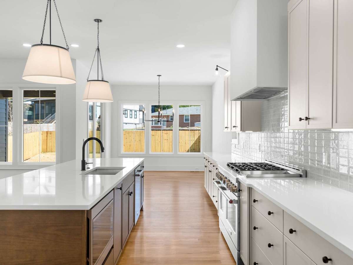 this kitchen includes an oversized island and 48" gas range