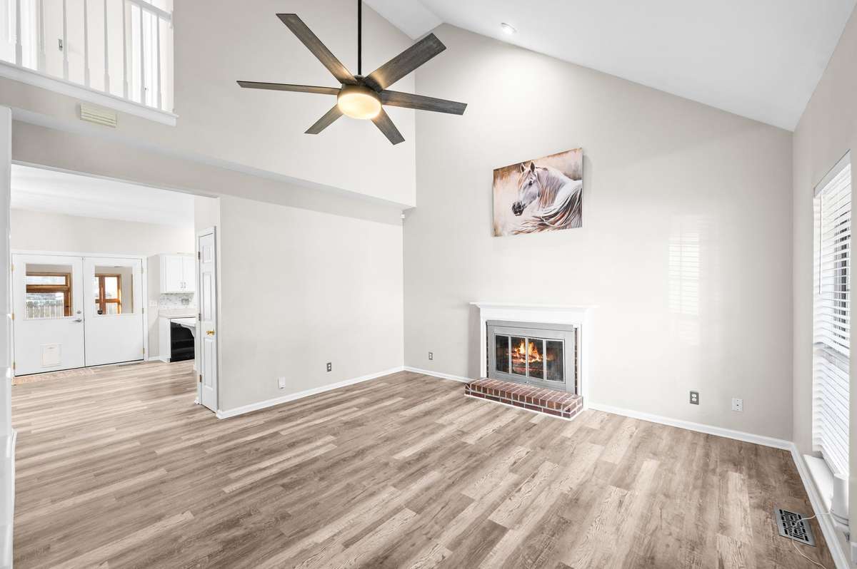 Living Room features Vaulted Ceilings and Wood burning fireplace