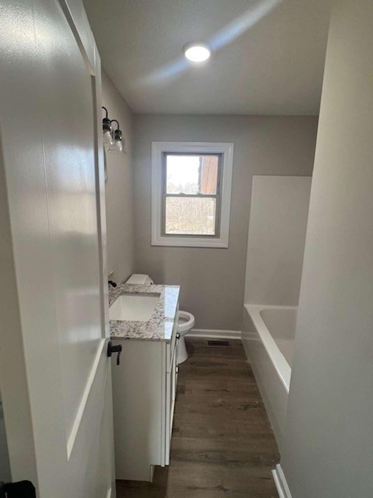 New tub/shower, new toilet, new vanity/mirror, new light fixtures, doors and flooring.
