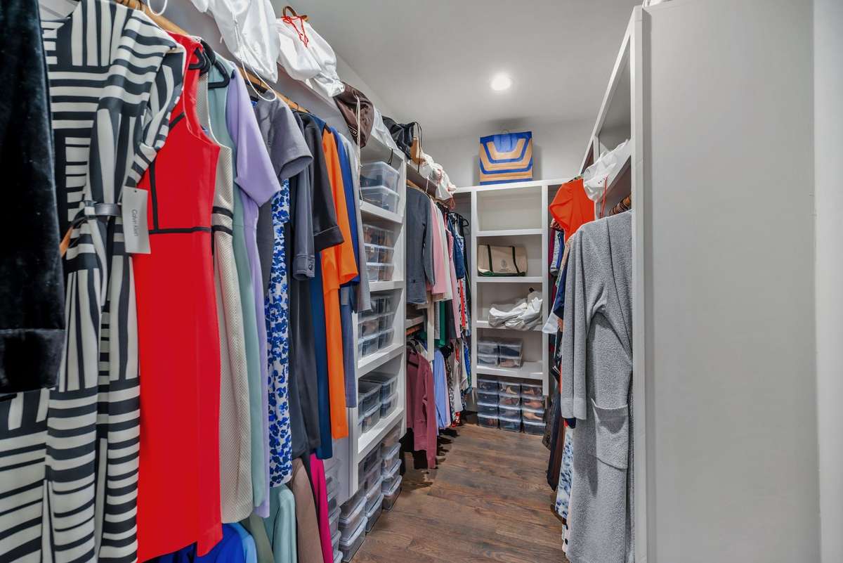 Primary Walk-In closet w Custom Built-Ins