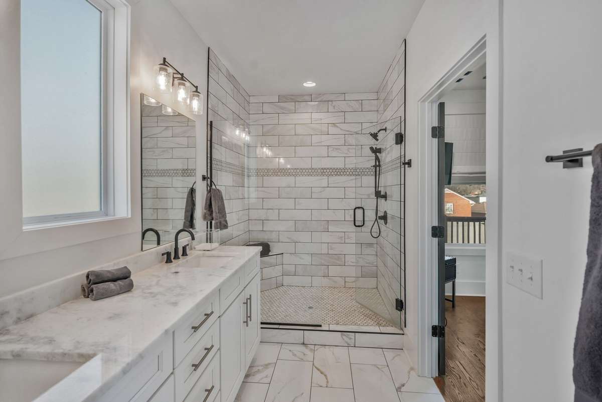 Primary Bath with Custom Walk-In Shower and Oversized Vanity Beautiful Tile-work Complete this Spa Like Bath
