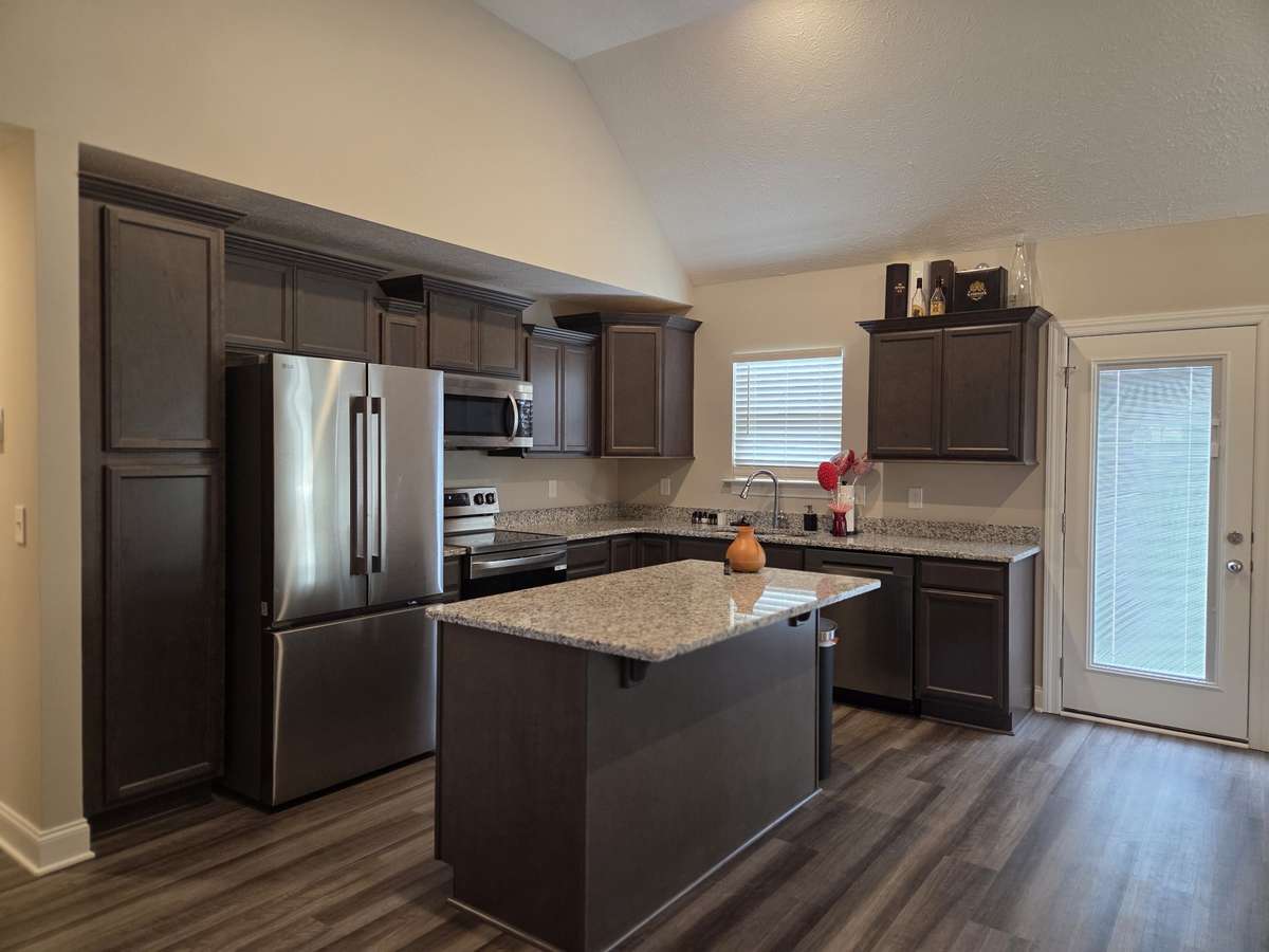 Fantastic Kitchen with Custom Cabinets, Granite Tops and Upgraded Stainless Refrigerator, Stove, Microwave and Dishwasher.