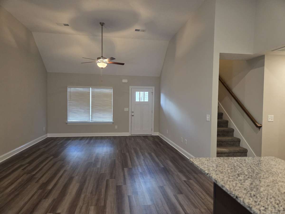 Spacious Living Room with Vaulted Ceiling and Plank Flooring.