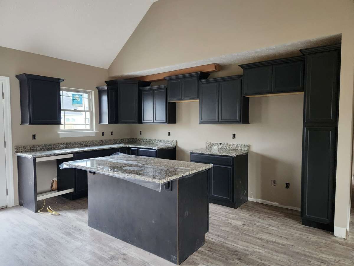 Kitchen has an Abundance of Custom Cabinets and a Large Island.