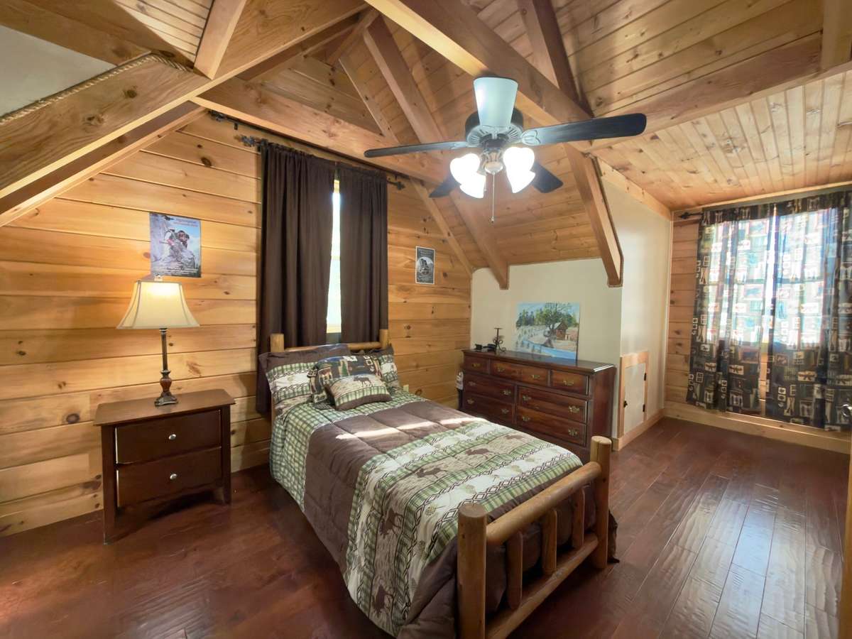 Upstairs bedroom with closet and extra hidden wall storage. Plentiful natural lighting with 3 windows.