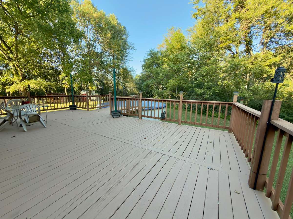 Spacious back deck overlooking the woods.