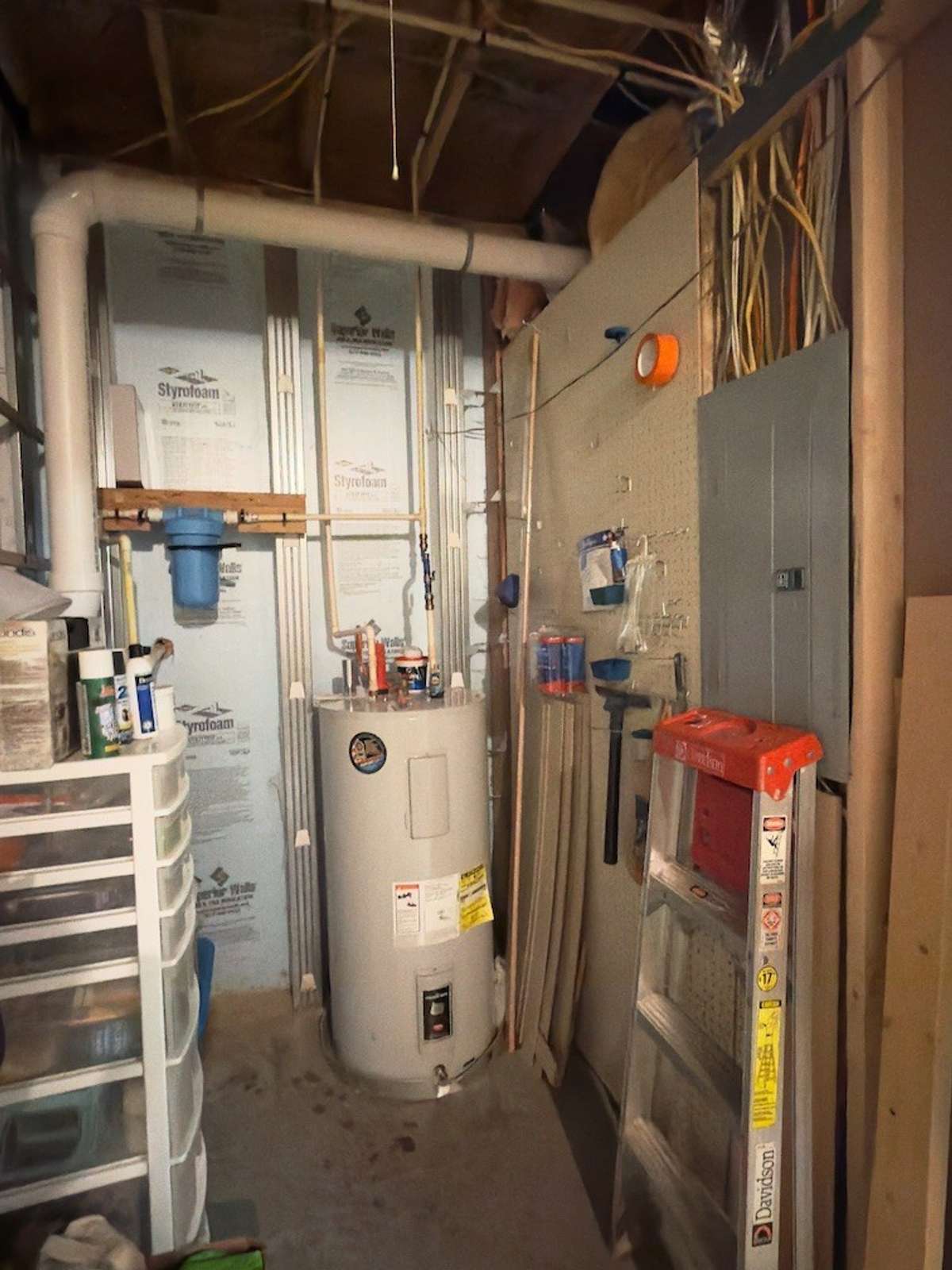 Utility room downstairs in basement.  Water filtration system, water heater, electrical panel and storage all in one area!