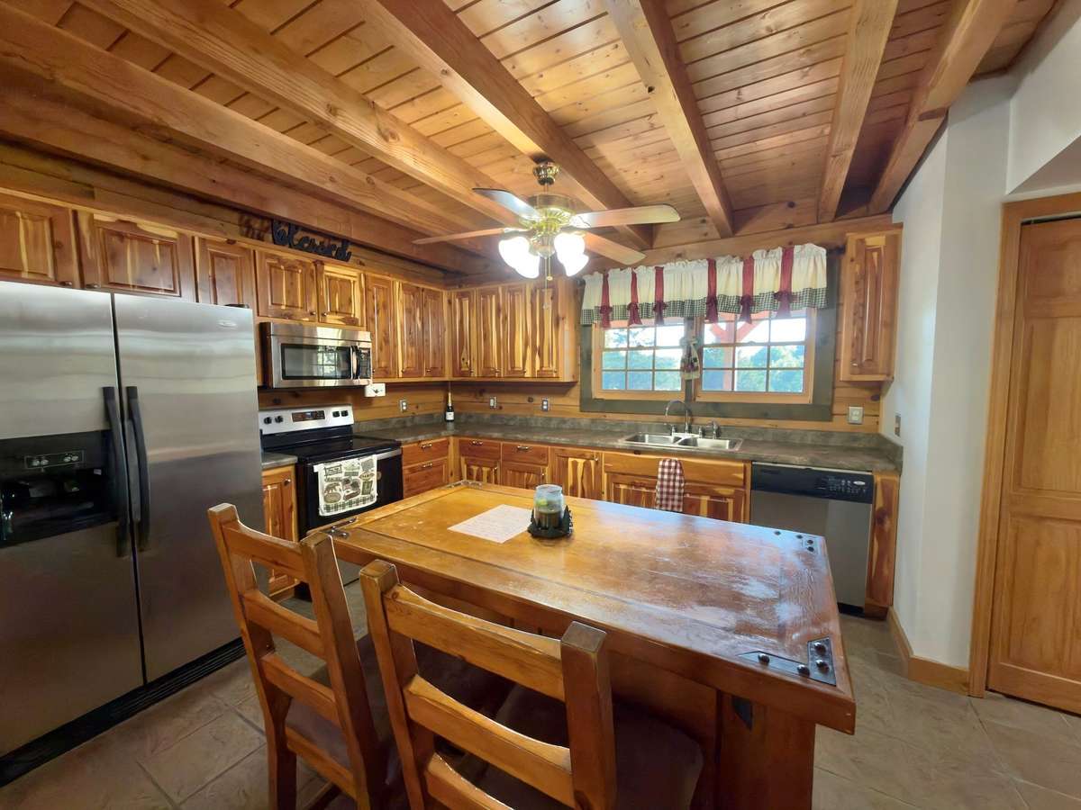 Kitchen with stainless appliances, island and custom cedar cabinets!