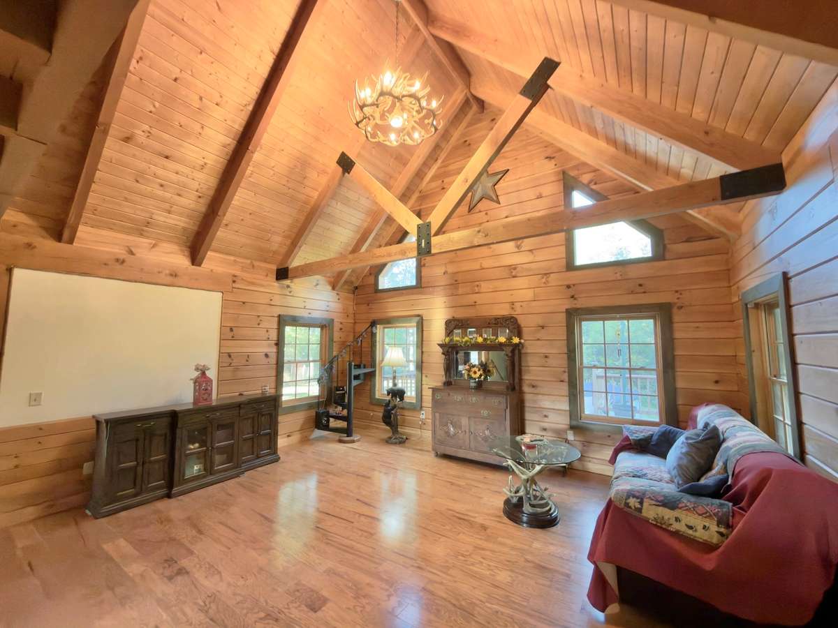 Great room with log beams and cathedral ceiling!
