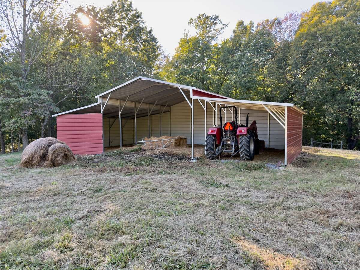 Metal barn/shed could be finished out for stables or hay storage.