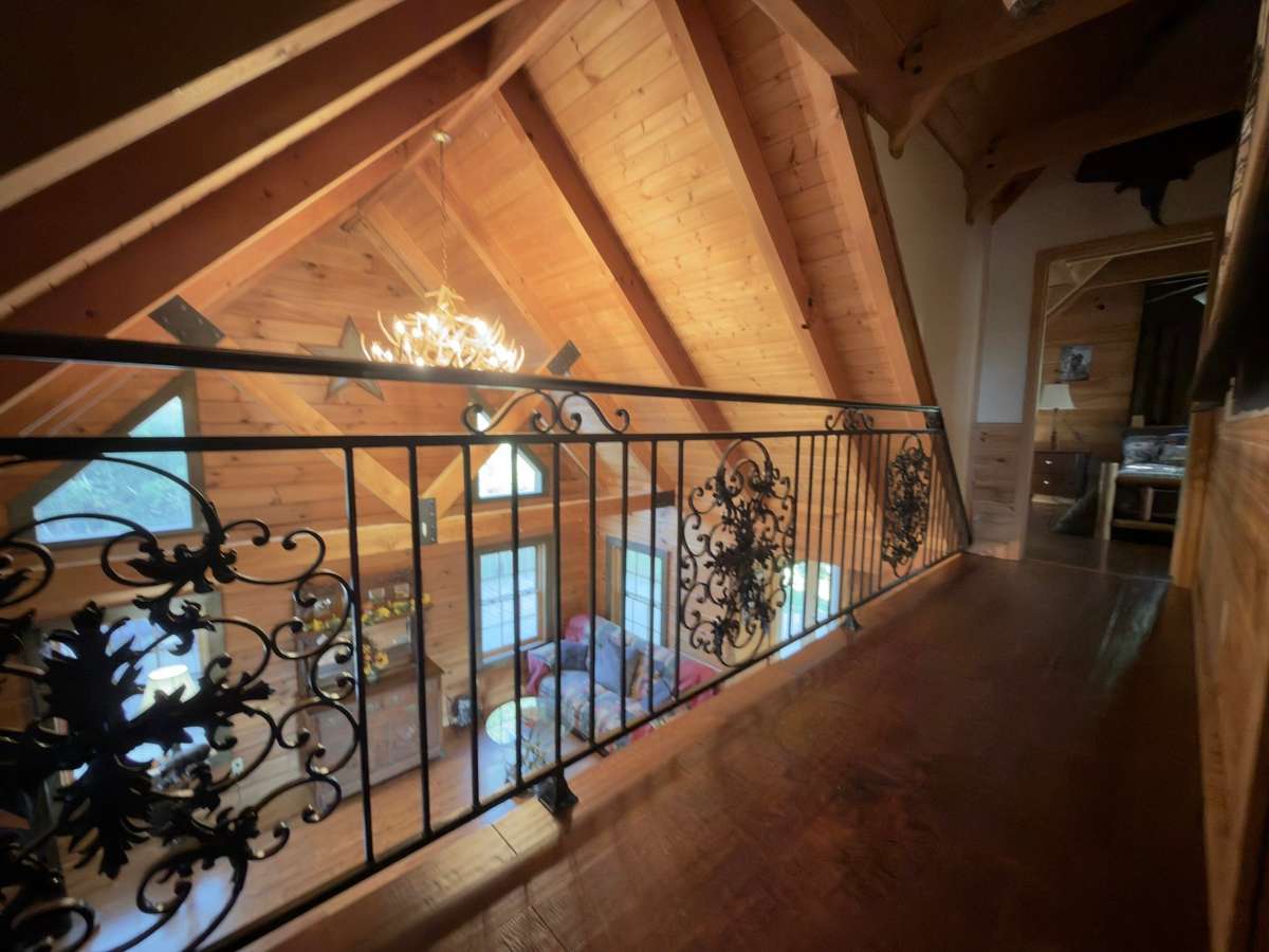 Custom wrought iron railing upstairs overlooking the great room.