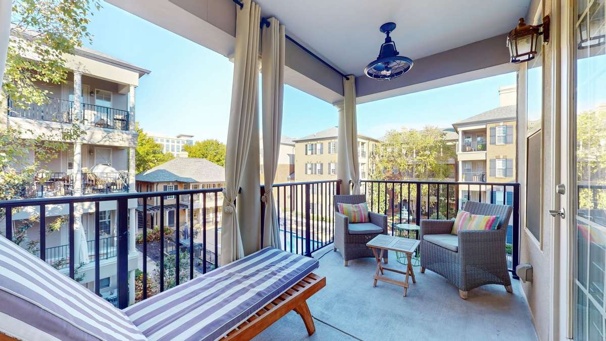 Phantom door screens, two outdoor oscillating ceiling fans, and privacy curtains create the perfect retreat