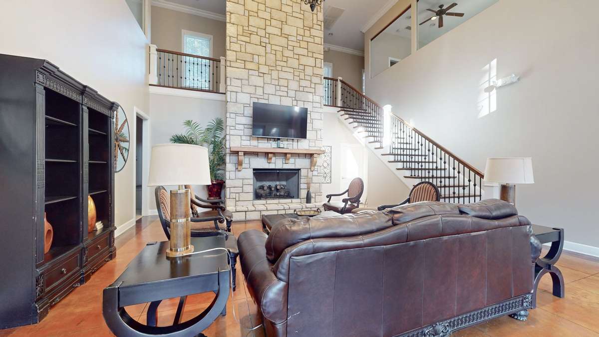 The clubhouse features two enclosed upstairs workout studios and a large gathering space with a kitchen for residents.