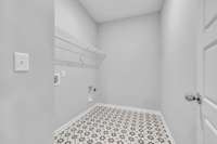 Oversized Laundry Room Located on the Main Level with Ceramic Tile Flooring.