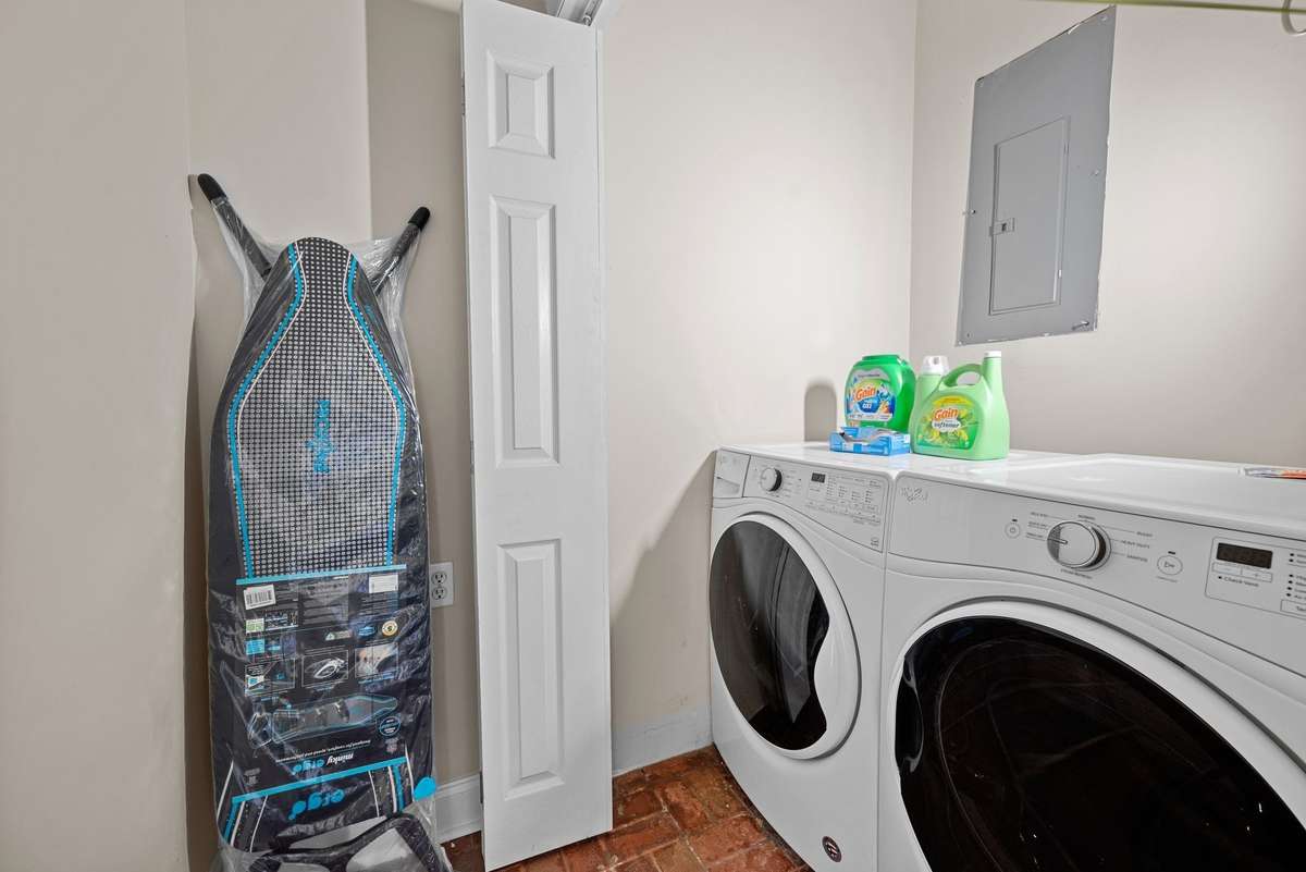 The laundry room is conveniently located next to the kitchen.