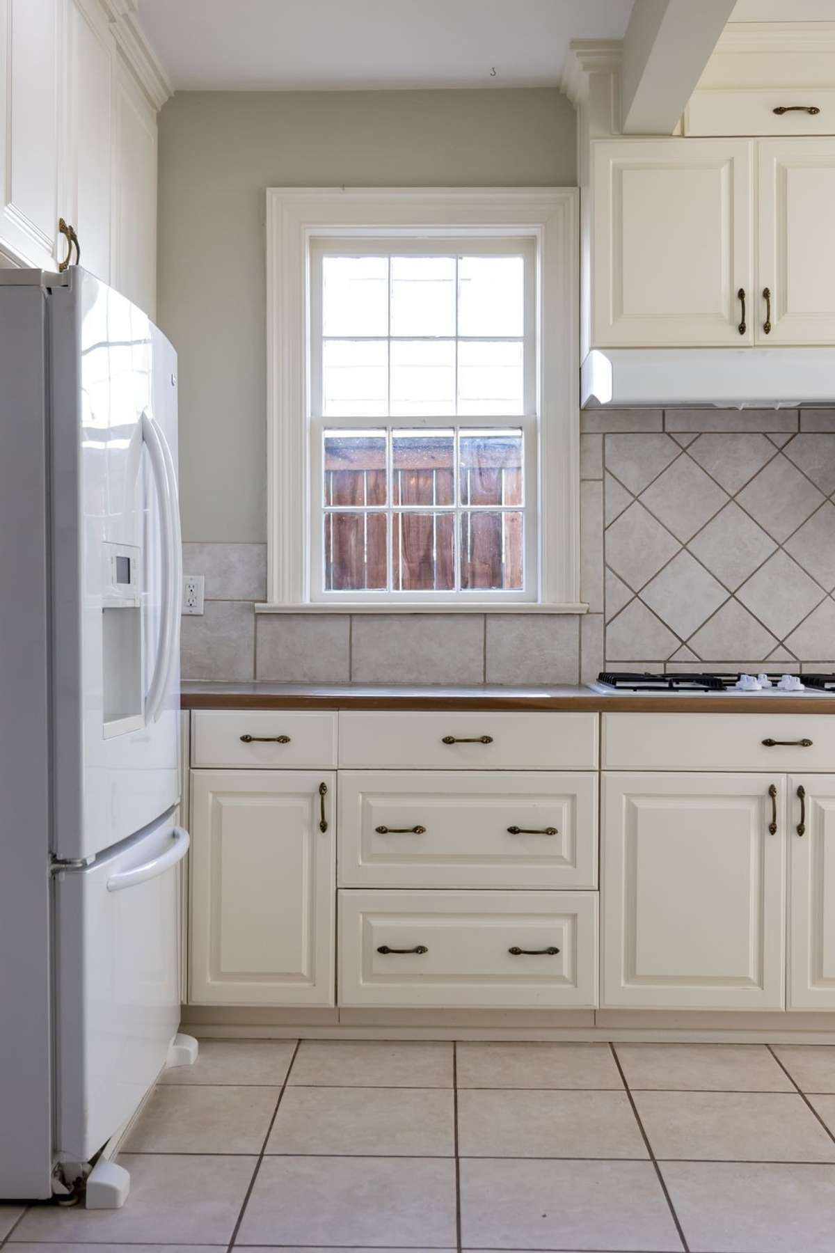 Cream cabinets and natural light add warmth to the space.