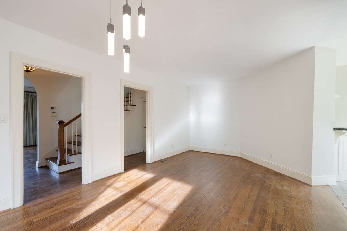 Open sightlines connect the dining room to the hallway and kitchen, emphasizing the home’s functional layout and renovation potential.