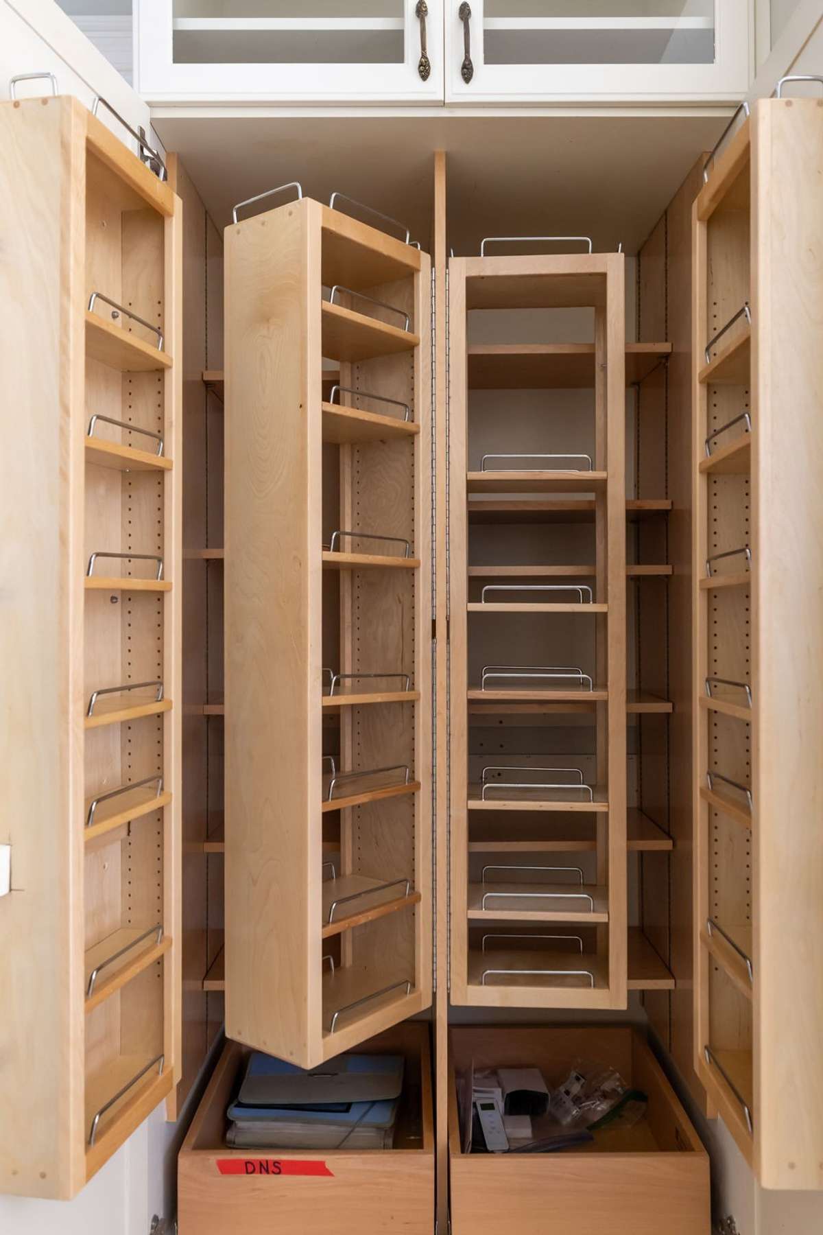 This pantry has ample storage with pull-out wood shelves that maximize the space
