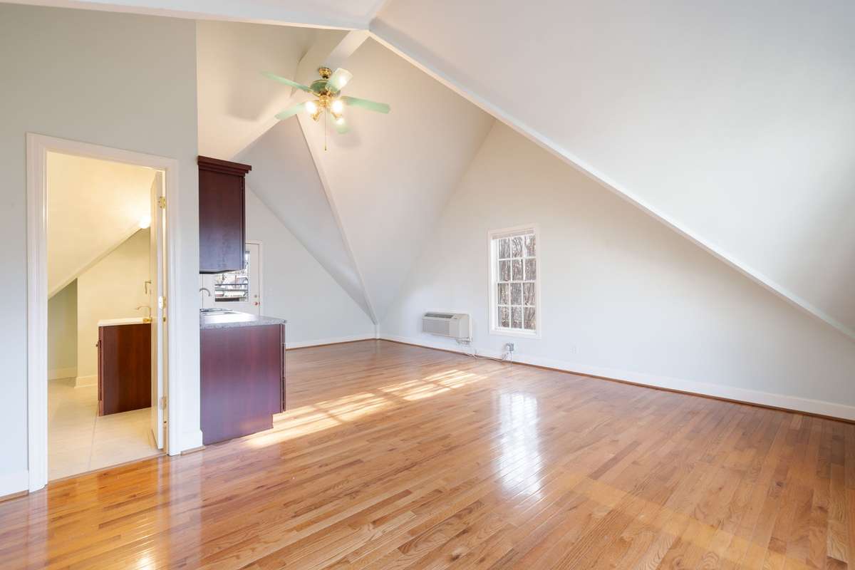Bright upper-level room with sloped ceilings and hardwood floors. Clean lines and open layout provide versatility for a variety of uses.