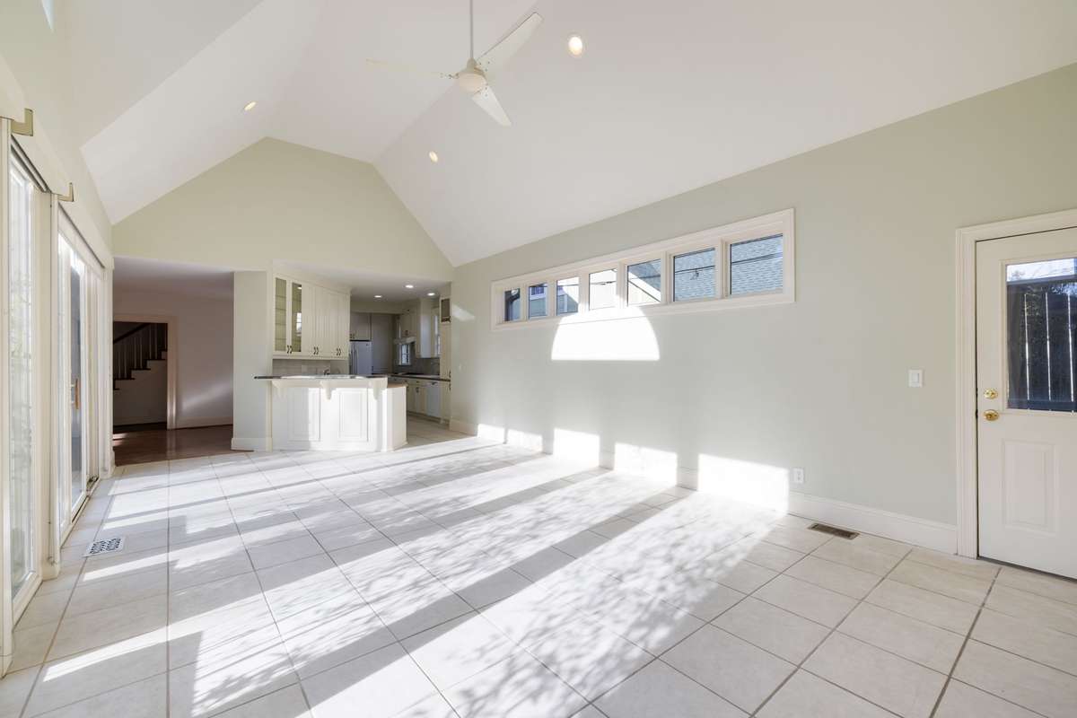 Soaring ceilings, ceiling fan, and abundant natural light throughout this versatile gathering space.