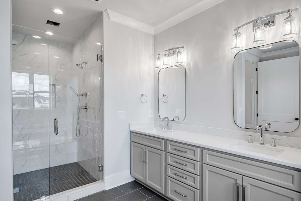 Primary Bathroom to include oversized double vanity, quartz countertops, tile flooring and oversized shower tiled to ceiling