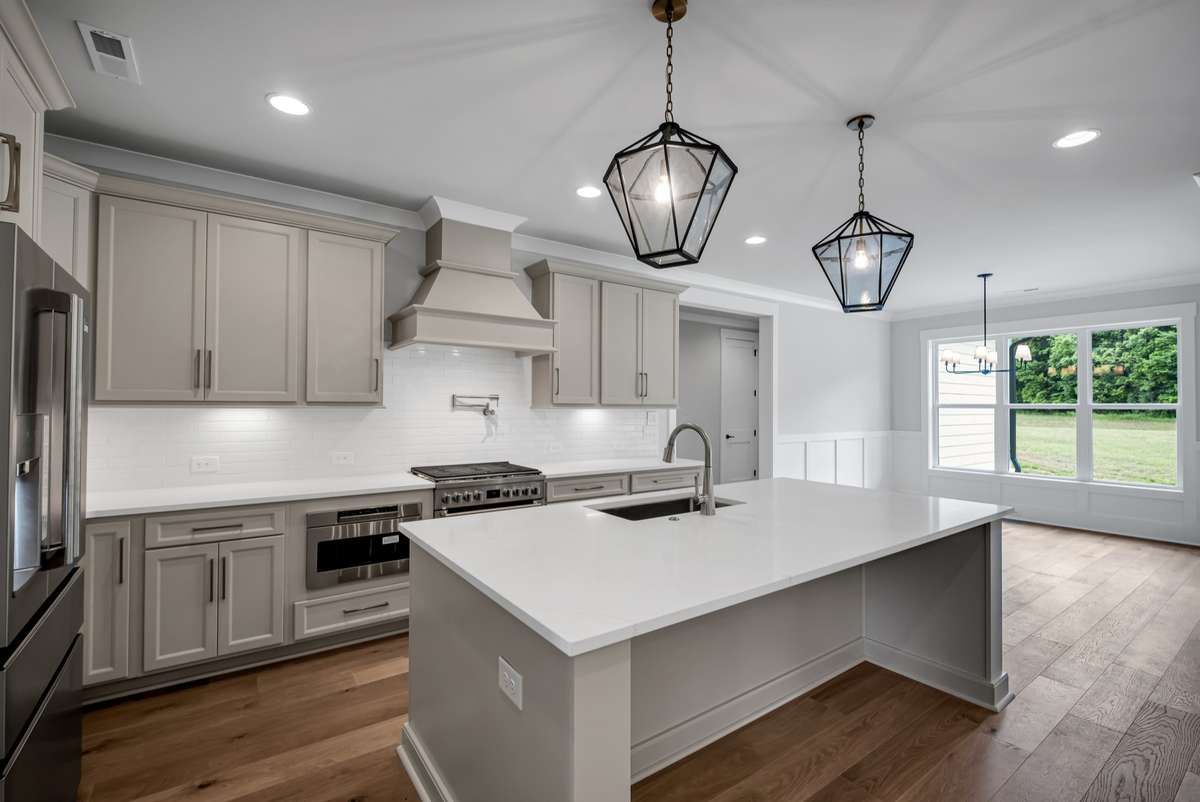 Gourmet Kitchen will feature an oversized island, quartz countertops with ceramic tile backsplash or coordinating quartz backsplash, soft close drawers throughout, and stainless steel appliance package