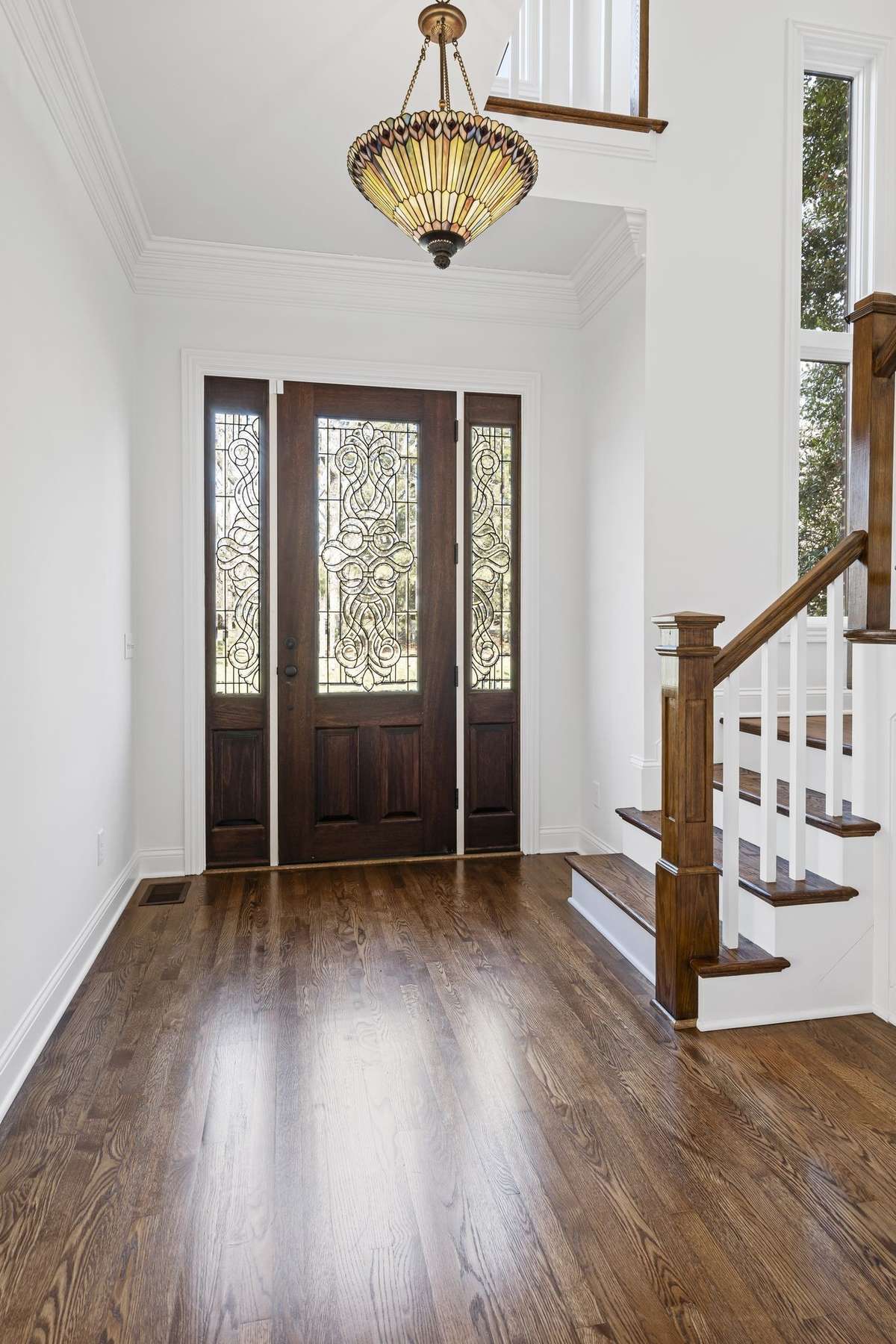 Welcome, view of front staircase and beautiful etched front door.