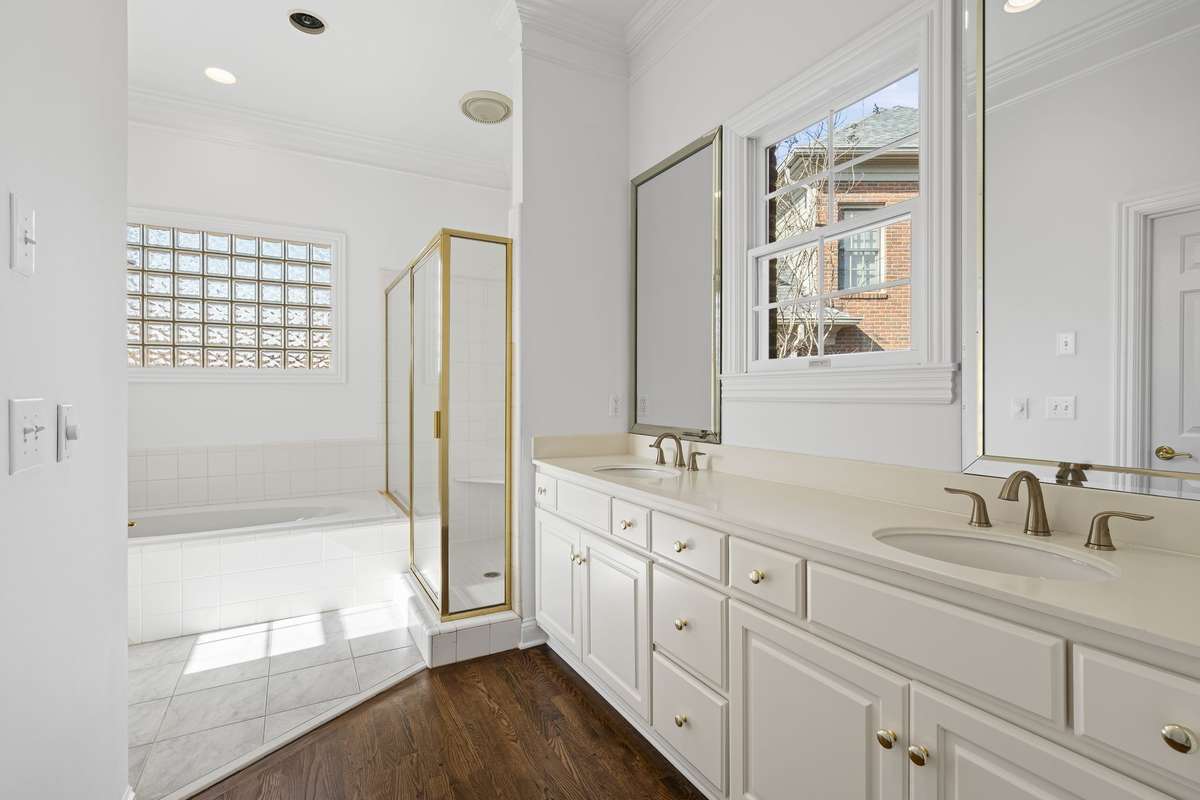 Primary bath with double vanities, separate shower and tub. 2 walk in closets.