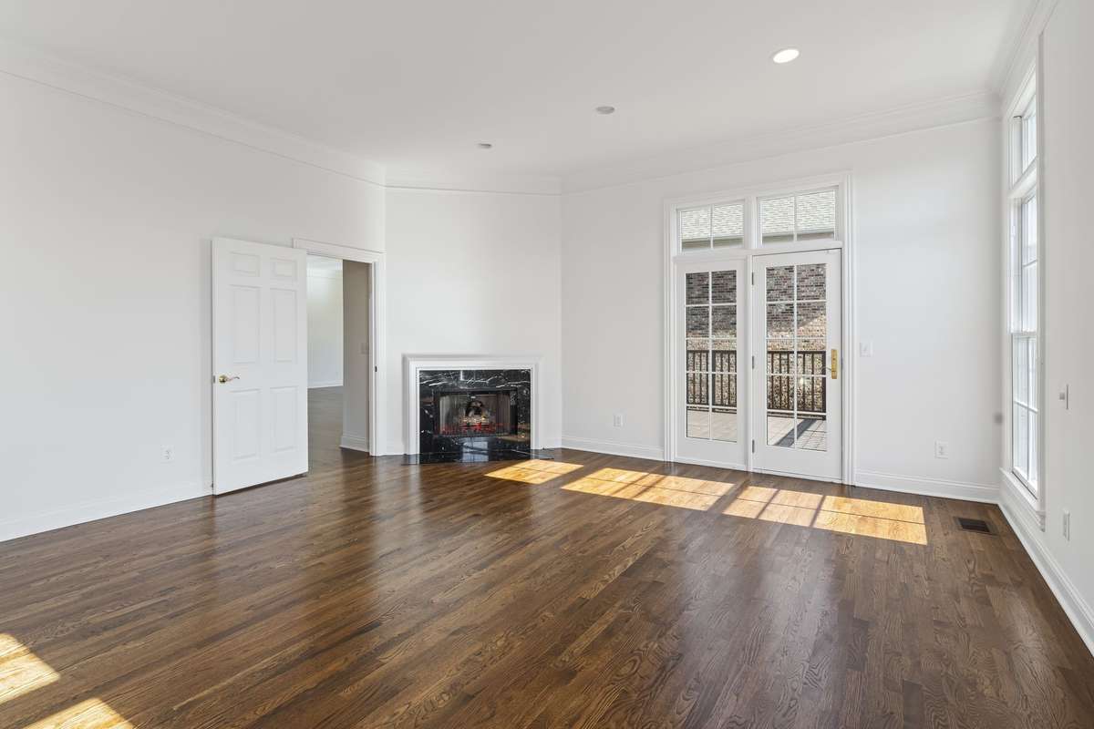 Primary suite with another marble surround gas fireplace. Access to lovely deck from suite.