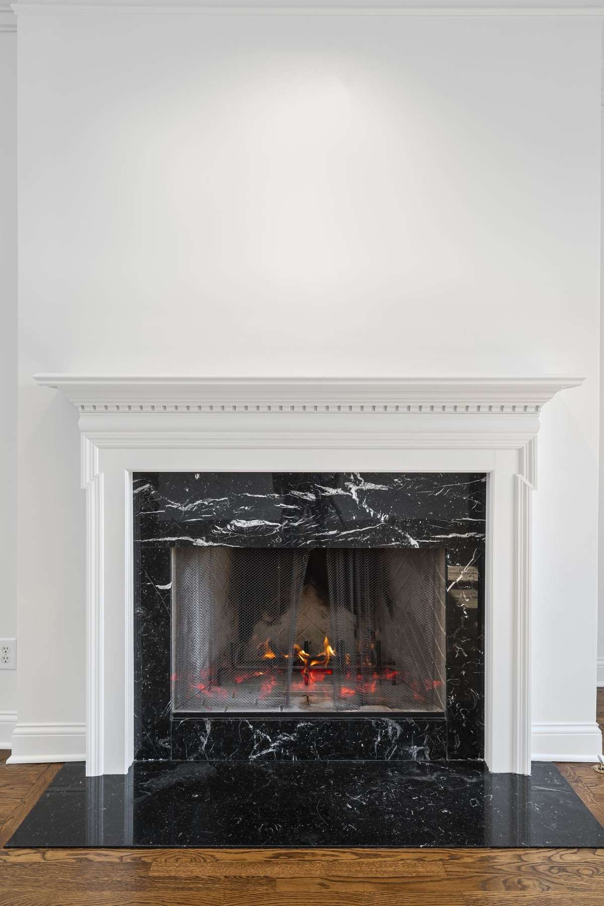 Marble surround fireplace in great room.
