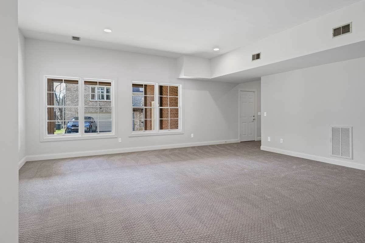 Downstairs hang out area with lots of light and new carpet. Easy access to outside.