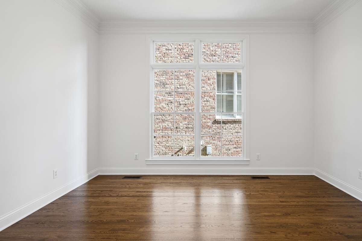 Main floor living room, music room or office with gorgeous hardwood floors and floor to ceiling windows. French doors to close off for privacy.